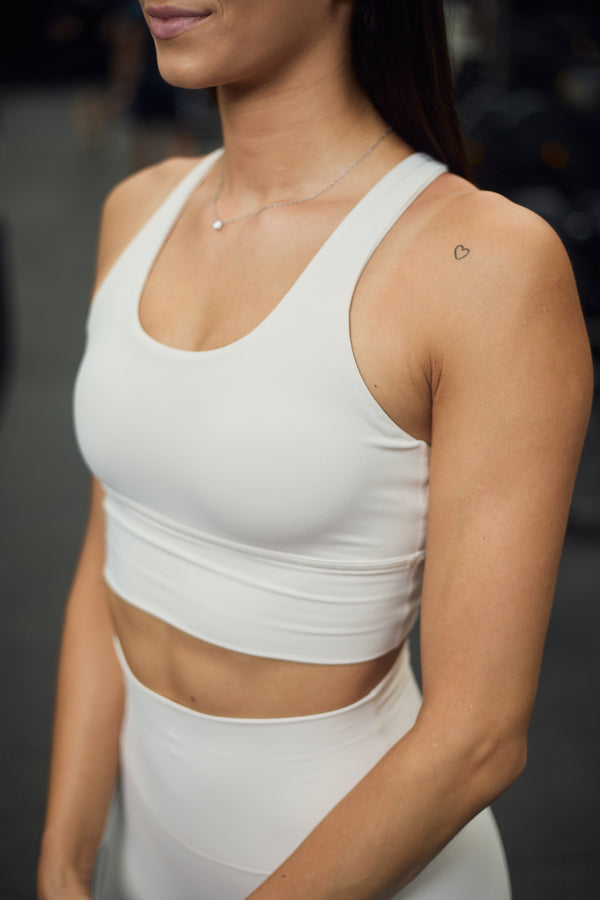 Elise 2.0 Sports Bra in light beige. Made from high-quality, second-skin material, it is supportive and comfortable. It features a unique open back design; perfect for your next workout or casual wear.